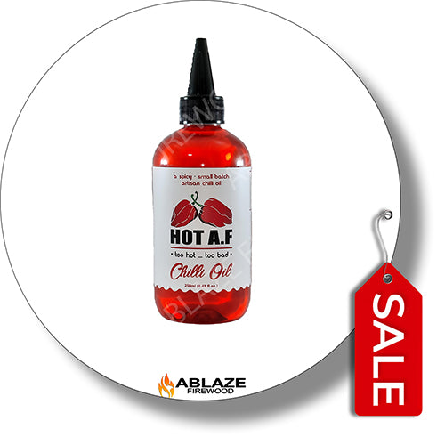 Bottle of Hot A.F. Chilli Oil with a sale tag on a white background